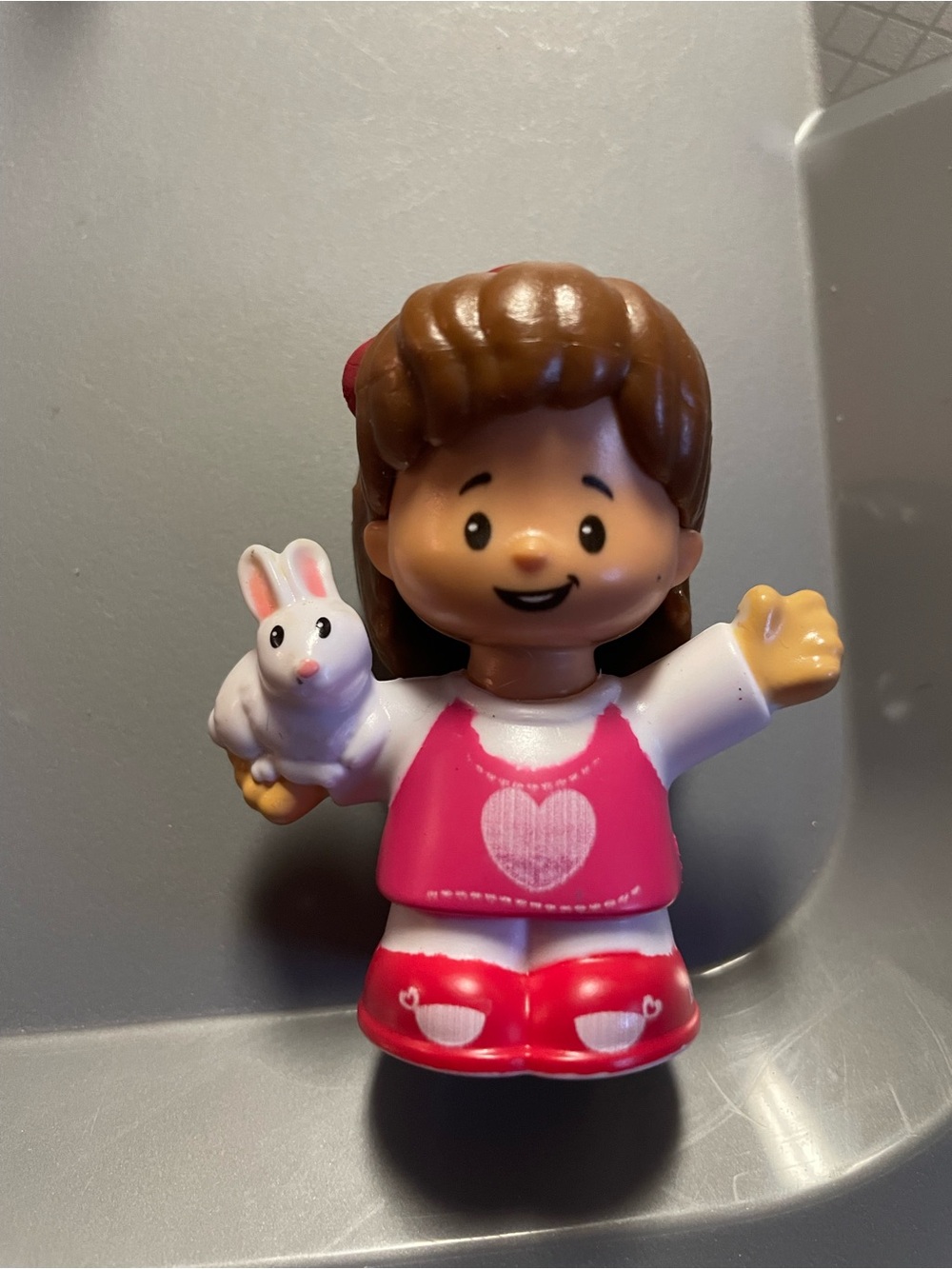 Fisher-Price Little People Mia Girl Figure in Pink Outfit with White Bunny